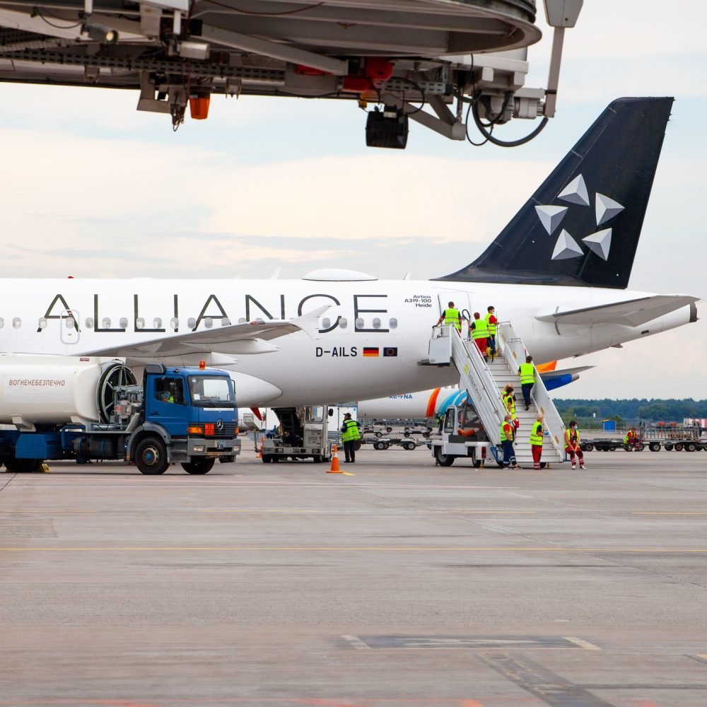 Passenger plane German airline STAR ALLIANS Airbus A-319 D-AILS. Airport apron workers. Maintenance refueling and interior cleaning. Airplane Lufthansa arrives. Ukraine, Kyiv - September 1, 2021.