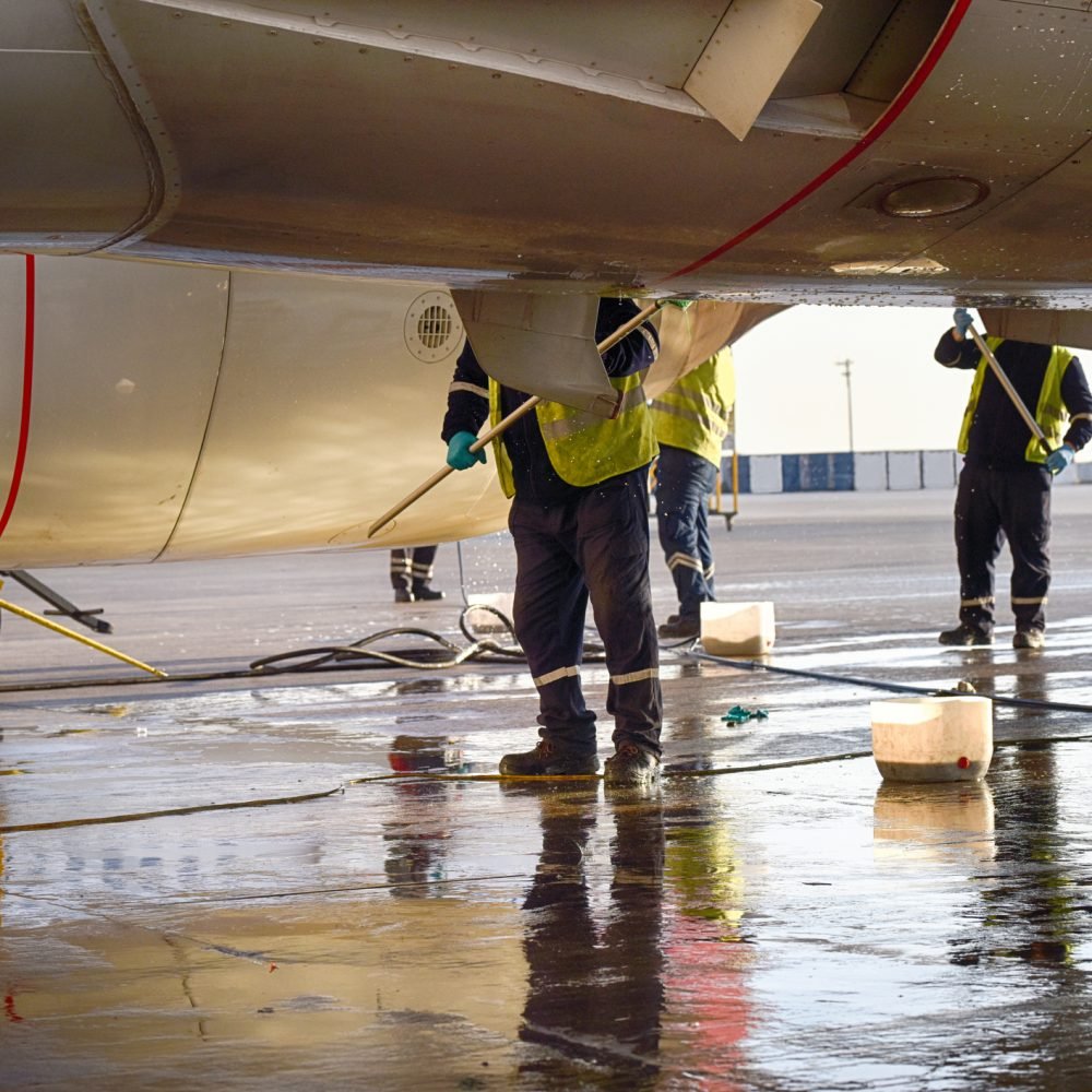 Airplane technicians washing the plane