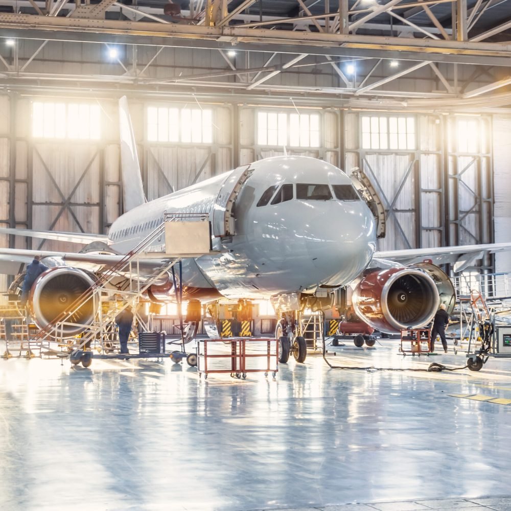 View inside the aviation hangar, the airplane mechanic working around the service